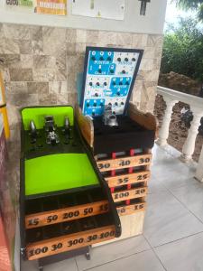 a game room with two controllers and a green seat at Finca Hotel Villa el Ocaso Huila in Rivera