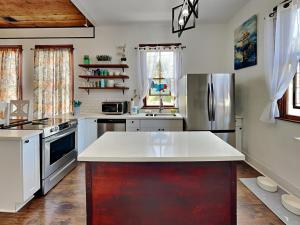 a kitchen with a white counter top and a refrigerator at The Vintage Sea Turtle in Galveston