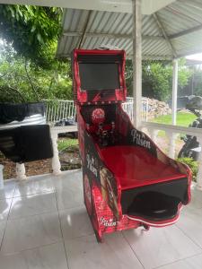 a red trunk with a tv inside of it at Finca Hotel Villa el Ocaso Huila in Rivera