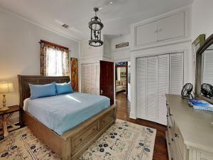 a bedroom with a bed and a desk in a room at The Vintage Sea Turtle in Galveston