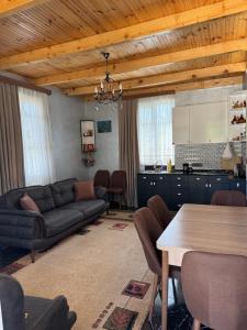 a living room with a couch and a table at Green Field Cottage,Chakvi in Batumi