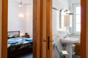 a bathroom with a sink and a bed at Manzoni Apartment in Le Castella