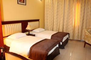 Postel nebo postele na pokoji v ubytování Aryana Hotel