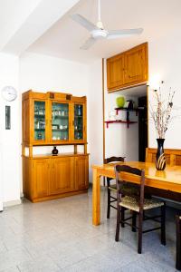a kitchen with a wooden table and a dining room at Manzoni Apartment in Le Castella