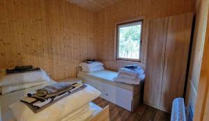 a room with two beds and a window at Marina Złotowo in Złotowo