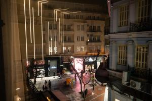 a view of a street at night from a building at Kalma Luxury Living Athens in Athens