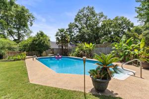 a swimming pool in the backyard of a house at Mins to Zoo - Capitol Heights Hideaway in Montgomery