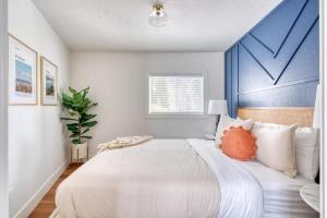 a bedroom with a large bed with a blue headboard at Stay Portland - Brooklyn 1 Bedroom Stylish Suite in Portland
