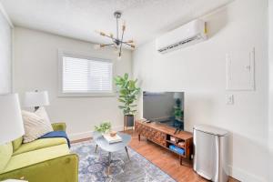 a living room with a couch and a tv at Stay Portland - Beautiful Brooklyn 1 Bed Apt in Portland