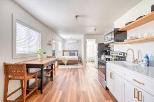 a kitchen with a table and a dining room with a bed at Stay Portland - Amazing Giant Studio in Brooklyn in Portland +30 photos