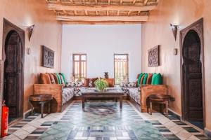 a living room with a couch and chairs at Kasbah Tiziri in El Kelaa des Mgouna