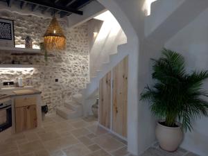 a kitchen with a staircase and a potted plant at La Boheme in Níjar