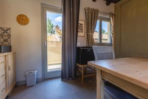a kitchen with a table and a large window at Palazzo San Biagio in Viterbo
