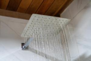 a white light hanging from a ceiling with crystals at Cabaña "Los Cedros", Sumak Cabañas in Baeza +42 photos