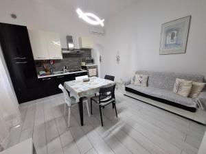 a kitchen and a living room with a table and a couch at Casa Carlo La Spezia in La Spezia
