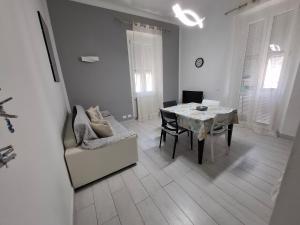 a white living room with a table and a chair at Casa Carlo La Spezia in La Spezia +6 photos