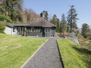 a house with a pathway leading to it with a yard at Bwthyn y Coediwr The Woodcutters Cottage in Blaenau-Ffestiniog