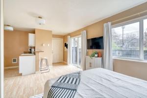 a bedroom with a large bed and a kitchen at Stay Portland - John's Landing Haven - Studio Near OHSU in Marquam Hill
