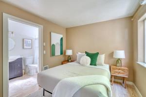 a bedroom with a large bed and a bathroom at Stay Portland - Peaceful Johns Landing Studio - Near OHSU in Marquam Hill