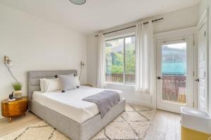 a white bedroom with a bed and two windows at Stay Portland - Perfect Portland Farmhouse Loft - Breweries & Bars in Portland