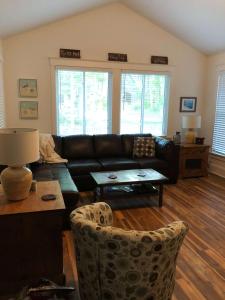 a living room with a couch and a table at The Chorus Frog - 8 Hollow in Cherry Valley