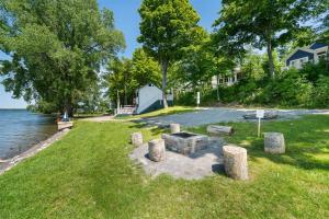 a picnic area on the shore of a lake with trees at The Chorus Frog - 8 Hollow in Cherry Valley +77 photos