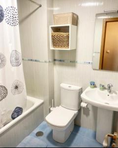 a white bathroom with a toilet and a sink at Lula Apartamento in Betanzos +38 photos