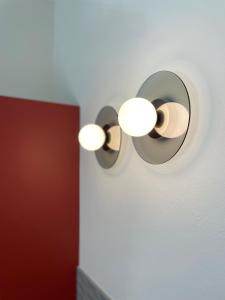 a pair of lights on a wall at PiANO NOBILE in Brescia