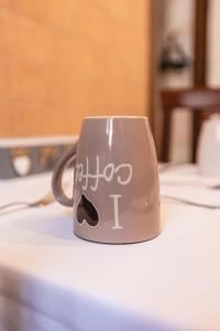 a coffee cup with writing on it on a table at Palazzetto San Lorenzo in Viterbo