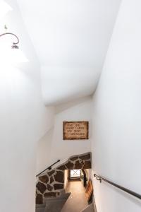 a staircase in a house with a stone wall at Palazzetto San Lorenzo in Viterbo
