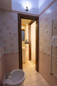 a bathroom with a sink and a toilet and a light at Palazzetto San Lorenzo in Viterbo +55 photos