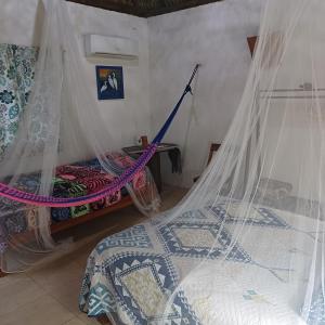 Voodi või voodid majutusasutuse Mayan Bungalow Near Chichén toas