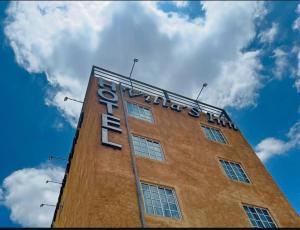 a tall building with a sign on top of it at Hotel Villas Inn in Sofía