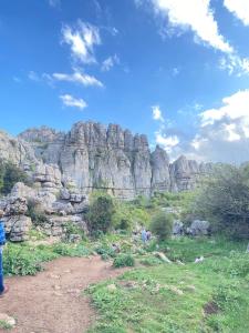 a group of people standing in front of a mountain at Apartamento Trébol in Antequera