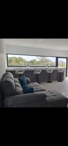 a couch in a room with a large window at Bella Casa Total House in São Francisco