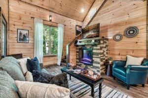a living room with a couch and a fireplace at Bear Up There Cabin by Avada Properties in Pigeon Forge
