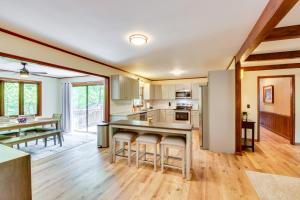 a kitchen with white cabinets and a table with bar stools at Deck and Game Room Mountaintop Hideaway in Tiger! in Tiger