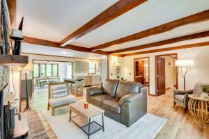 a living room with a leather couch and a table at Deck and Game Room Mountaintop Hideaway in Tiger! in Tiger