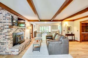 a living room with a brick fireplace and a leather couch at Deck and Game Room Mountaintop Hideaway in Tiger! in Tiger