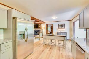 a kitchen with white cabinets and a stainless steel refrigerator at Deck and Game Room Mountaintop Hideaway in Tiger! in Tiger