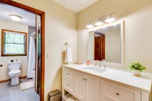 a bathroom with a sink and a toilet and a mirror at Deck and Game Room Mountaintop Hideaway in Tiger! in Tiger