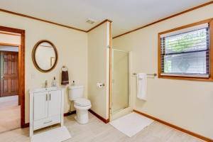 a bathroom with a toilet and a sink and a mirror at Deck and Game Room Mountaintop Hideaway in Tiger! in Tiger +32 photos