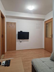a living room with a flat screen tv on a wall at Apartments Vidikovac in Međugorje