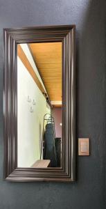 a mirror hanging on a wall in a room at Garden Suite in Valle de Bravo