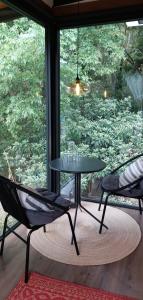 a table and two chairs in front of a window at Garden Suite in Valle de Bravo