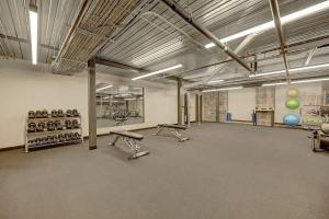 a large room with a gym with benches and balls on the wall at Elegant 2BD near Historic Pabst Brewery - Fiserv in Milwaukee