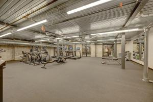 a gym with treadmills and exercise bikes in it at Spotless 1BD near Historic Pabst Brewery - Fiserv in Milwaukee