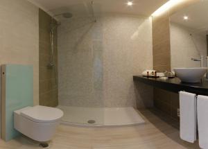 a bathroom with a shower and a toilet and a sink at Arribas Sintra Hotel in Sintra