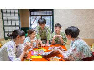a group of people sitting around a table at Kinugawa Park Hotels - Vacation STAY 96213v in Nikko