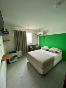 Ένα ή περισσότερα κρεβάτια σε δωμάτιο στο Suites Quebra Mar